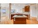 Open kitchen design with granite counters, hardwood floors, and gas cooktop island perfect for entertaining at 1975 Wild Star Way, Castle Rock, CO 80104