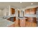 Kitchen boasts granite countertops, an island cooktop, stainless steel appliances, and wood floors at 1975 Wild Star Way, Castle Rock, CO 80104