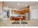 Bright eat-in kitchen with hardwood floors, stainless steel appliances, and granite countertops at 1975 Wild Star Way, Castle Rock, CO 80104