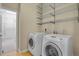 A well-equipped laundry room with modern washer, dryer, and metal shelving for storage at 1975 Wild Star Way, Castle Rock, CO 80104