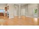 Bright living area featuring hardwood floors and elegant architectural columns and archways at 1975 Wild Star Way, Castle Rock, CO 80104