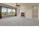 Living room with fireplace, carpeted floors, and large windows at 1975 Wild Star Way, Castle Rock, CO 80104