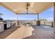Covered outdoor patio with outdoor kitchen, built in grill and dining set at 1975 Wild Star Way, Castle Rock, CO 80104