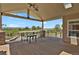 Covered patio offers stunning views with outdoor seating and ceiling fan at 1975 Wild Star Way, Castle Rock, CO 80104