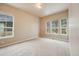 Bright room featuring carpet, light-colored walls, and windows with a neighborhood view at 1975 Wild Star Way, Castle Rock, CO 80104