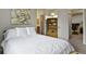 Comfortable bedroom with a queen-size bed and adjacent bathroom and loft access at 1320 S Monaco St Pkwy # 3, Denver, CO 80224