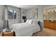 Cozy bedroom with a plush bed, bright window, and ensuite bathroom access at 1320 S Monaco St Pkwy # 3, Denver, CO 80224
