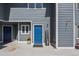 Charming blue front door with a 'Welcome' sign adds curb appeal at 1320 S Monaco St Pkwy # 3, Denver, CO 80224