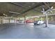 Spacious parking garage with painted lines, visible ceilings, and several parked vehicles at 1320 S Monaco St Pkwy # 3, Denver, CO 80224