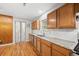 Modern kitchen featuring granite counters, wood cabinets, and a stainless steel dishwasher at 1325 Dayton St, Aurora, CO 80010