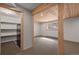 Finished basement with window, wood ceiling, carpet, and shelving, providing a cozy and functional space at 13609 Elsie Rd, Conifer, CO 80433