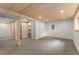 Finished basement featuring a sliding barn door, wood ceiling, and carpeted floor, perfect for a den or recreation area at 13609 Elsie Rd, Conifer, CO 80433
