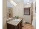 Bathroom featuring a granite vanity, tile shower, and wood-style flooring at 13609 Elsie Rd, Conifer, CO 80433