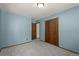 A bedroom with light blue walls and two closets at 13609 Elsie Rd, Conifer, CO 80433