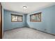A bedroom with light blue walls and natural lighting at 13609 Elsie Rd, Conifer, CO 80433