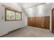 Bright bedroom featuring a large window with natural light, carpeted floor, and closet, providing a cozy retreat at 13609 Elsie Rd, Conifer, CO 80433