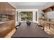 Open dining area with a large wood table, light wood floors, and scenic windows at 13609 Elsie Rd, Conifer, CO 80433