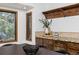 Bright dining area featuring wood cabinets, granite counters, and view-framing windows at 13609 Elsie Rd, Conifer, CO 80433
