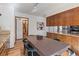 Dining area showcasing wood floors, cabinetry, and a glimpse into an adjacent bathroom at 13609 Elsie Rd, Conifer, CO 80433
