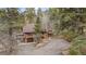 Exterior of a brown house surrounded by tall trees, showcasing a tranquil and private property at 13609 Elsie Rd, Conifer, CO 80433