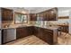 Well-lit kitchen featuring dark wood cabinets, granite countertops, and stainless steel appliances at 13609 Elsie Rd, Conifer, CO 80433