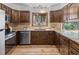 Well-appointed kitchen featuring modern appliances and dark wood cabinets with light countertops at 13609 Elsie Rd, Conifer, CO 80433