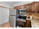 Well-equipped kitchen featuring stainless steel appliances and warm wood cabinetry and hardwood floors at 13609 Elsie Rd, Conifer, CO 80433