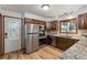 Fully equipped kitchen with stainless steel appliances, wood floors, and ample counter space at 13609 Elsie Rd, Conifer, CO 80433
