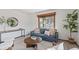 Comfortable living room with a blue sofa, round coffee table, and views from a large window at 13609 Elsie Rd, Conifer, CO 80433