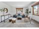 Bright living room with wood trim, a comfortable sofa, and a view-framing window at 13609 Elsie Rd, Conifer, CO 80433