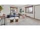 Inviting living room featuring a comfortable blue sofa, wood accents, and natural light at 13609 Elsie Rd, Conifer, CO 80433