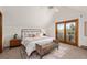 Bright main bedroom with a king bed, a balcony, and an ensuite bathroom at 13609 Elsie Rd, Conifer, CO 80433
