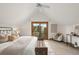 Bright bedroom featuring a seating area and balcony access through sliding glass doors at 13609 Elsie Rd, Conifer, CO 80433