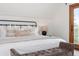 Bright main bedroom showcasing a king bed with balcony access at 13609 Elsie Rd, Conifer, CO 80433