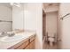 Clean bathroom with vanity, toilet, and shower featuring neutral tiling at 1833 N Williams St # 402, Denver, CO 80218