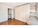 Bedroom featuring hardwood floors, an integrated closet, and a workstation at 1833 N Williams St # 402, Denver, CO 80218
