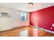 Bright bedroom with hardwood floors and large window; radiator and air conditioning at 1833 N Williams St # 402, Denver, CO 80218