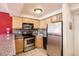 Cozy kitchen featuring stainless steel appliances and light wood cabinets at 1833 N Williams St # 402, Denver, CO 80218