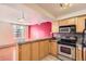 Well-lit kitchen area with stainless steel oven, microwave, and granite countertops at 1833 N Williams St # 402, Denver, CO 80218