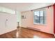 Living room with hardwood floors, white walls, and a window letting in natural light at 1833 N Williams St # 402, Denver, CO 80218