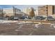 Exterior parking lot with various cars during winter with snow on the ground at 1833 N Williams St # 402, Denver, CO 80218