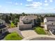 An aerial view of a two-story home with three-car garage, a pristine lawn, and mountain views in the distance at 11839 Saddleback Ct, Parker, CO 80138