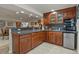 Home bar area featuring a granite countertop, dark wood cabinets, mini fridge, and decorative glassware at 11839 Saddleback Ct, Parker, CO 80138