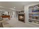 Finished basement featuring a fireplace, built in shelves, foosball table, and comfortable seating area at 11839 Saddleback Ct, Parker, CO 80138