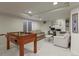 Finished basement features a foosball table, comfortable seating, desk area, neutral color scheme, and recessed lighting at 11839 Saddleback Ct, Parker, CO 80138