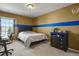 Bedroom featuring a bed, computer desk, and a black dresser with sports-themed decorations at 11839 Saddleback Ct, Parker, CO 80138