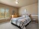 Comfortable bedroom with a cozy bed, dresser, and natural light from the window offers a peaceful retreat at 11839 Saddleback Ct, Parker, CO 80138