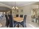 Dining room with a chandelier, seating for six, and entry to the living room at 11839 Saddleback Ct, Parker, CO 80138
