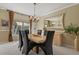 Dining room with a large mirror, a modern chandelier, and seating for six guests at 11839 Saddleback Ct, Parker, CO 80138