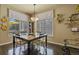 Dining area features a large table with seating, bookshelves, and natural light at 11839 Saddleback Ct, Parker, CO 80138